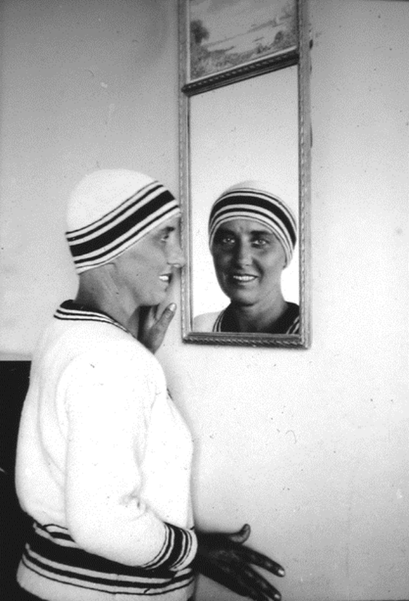 Marcel Moore in front of a mirror